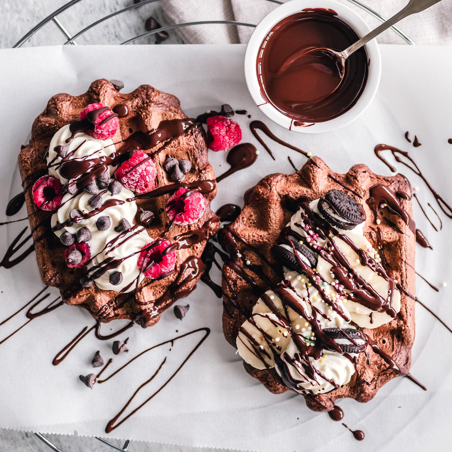 Chocolate waffles with cream, chocolate sauce, fruit and chocolate sandwich cookies