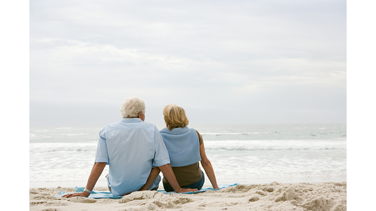 Senior couple sitting on a beach