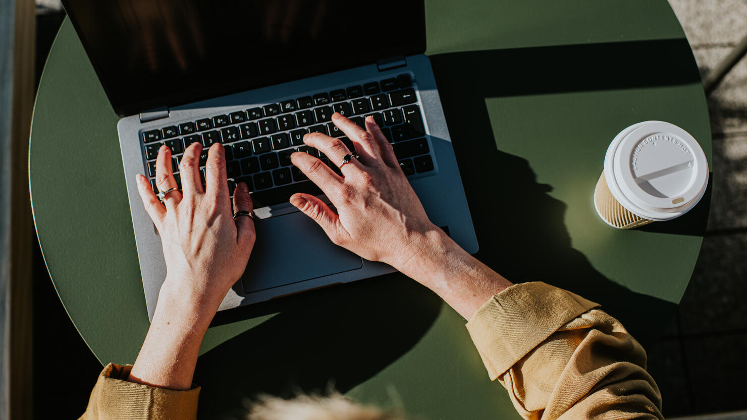 Close-up of hands typing on a laptop computer