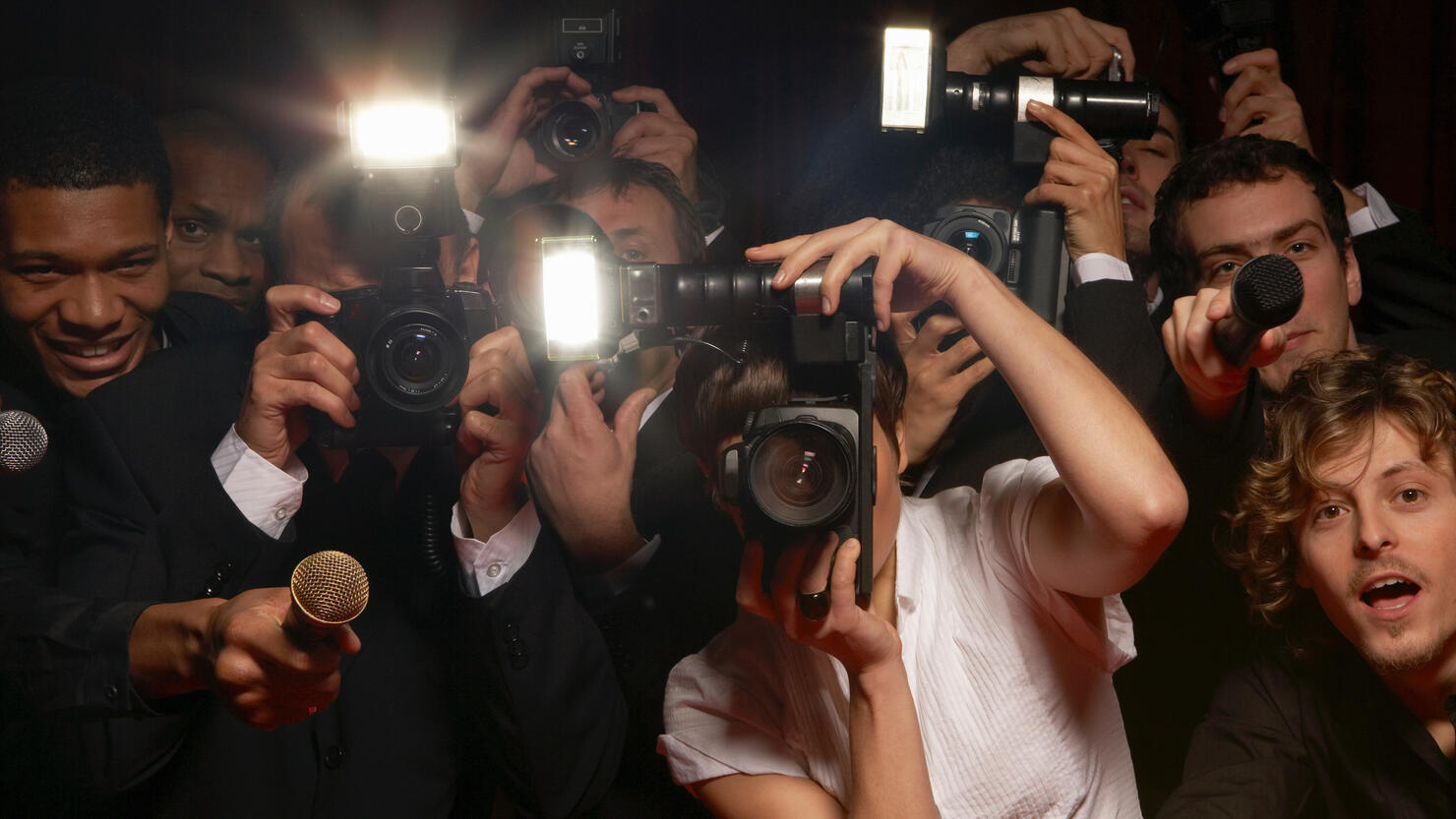 Paparazzi photographers and television reporters at celebrity event