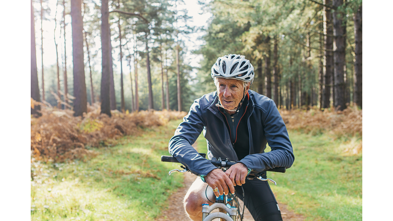 Senior male on bike in forest