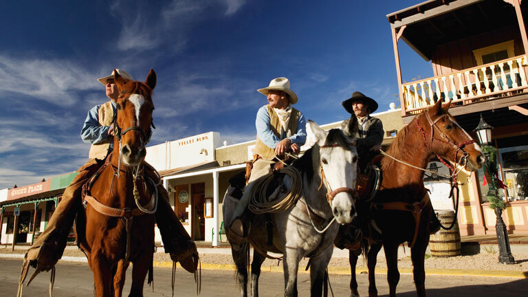USA, Arizona, Tombstone, three cowboys on horseback