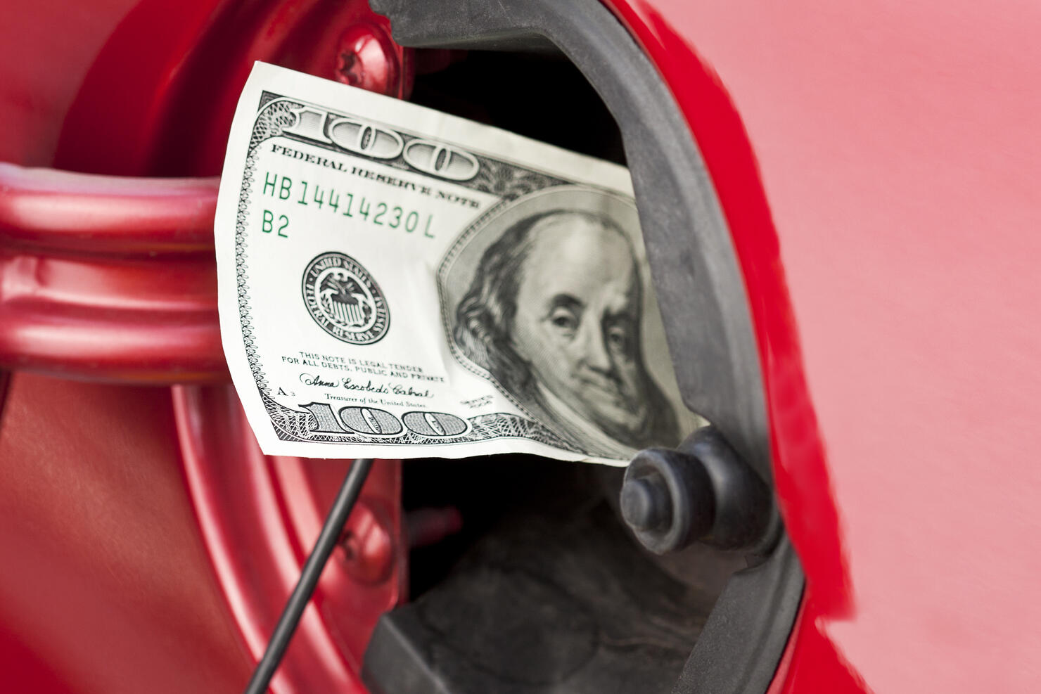 A hundred dollar bill stuffed into a cars gas tank