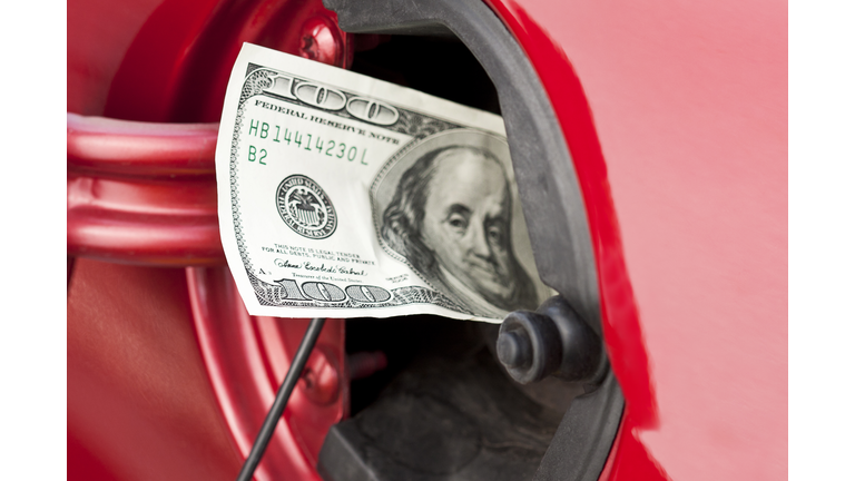 A hundred dollar bill stuffed into a cars gas tank