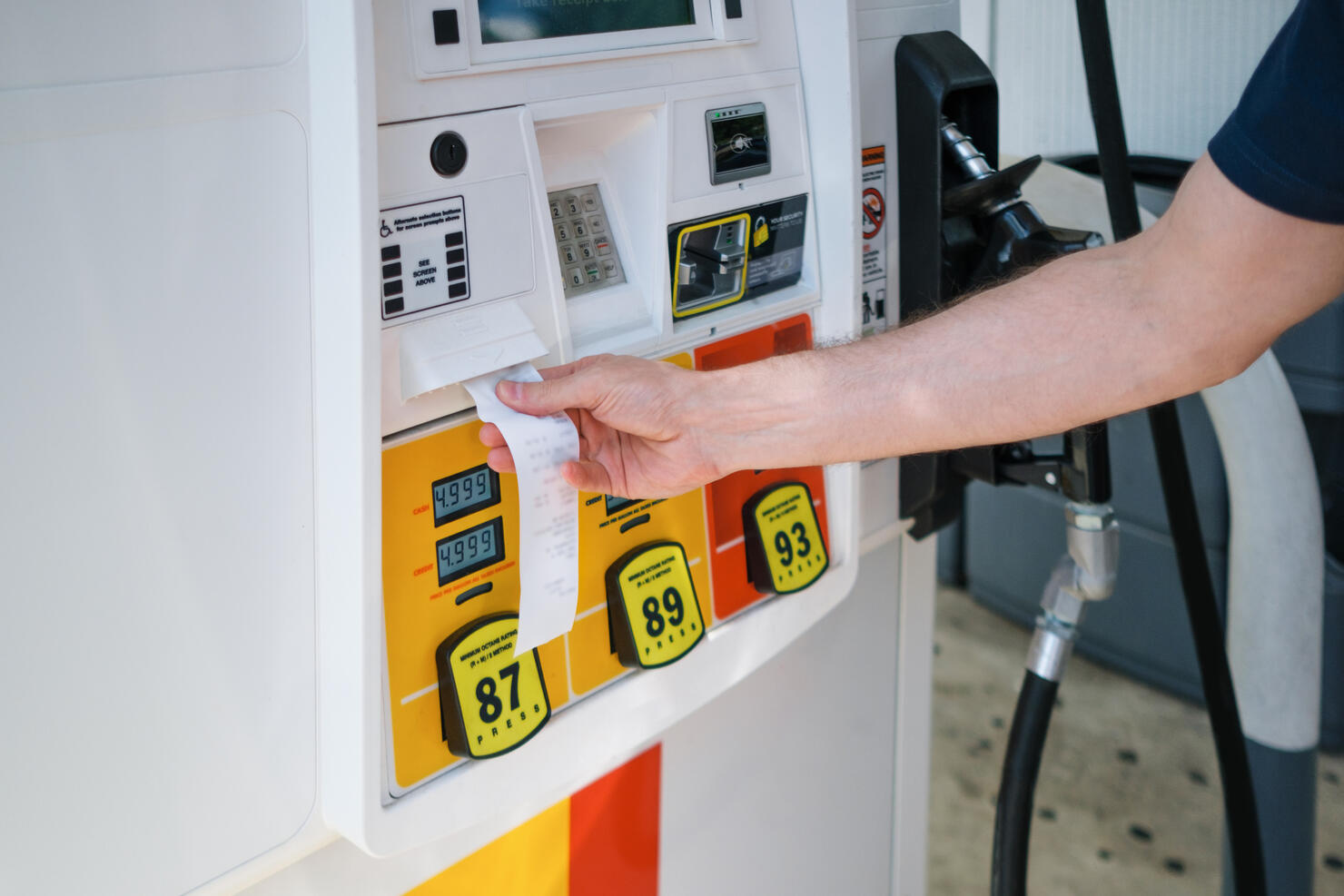 Man Purchases Gas at Pump Amid Skyrocketing Prices