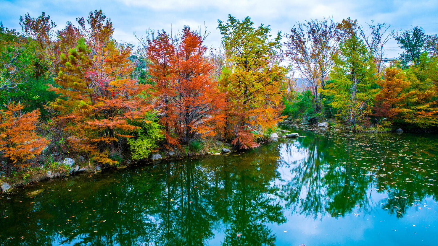 Tranquil Fall Leaves along mirrored water reflection at Red Bud Isle
