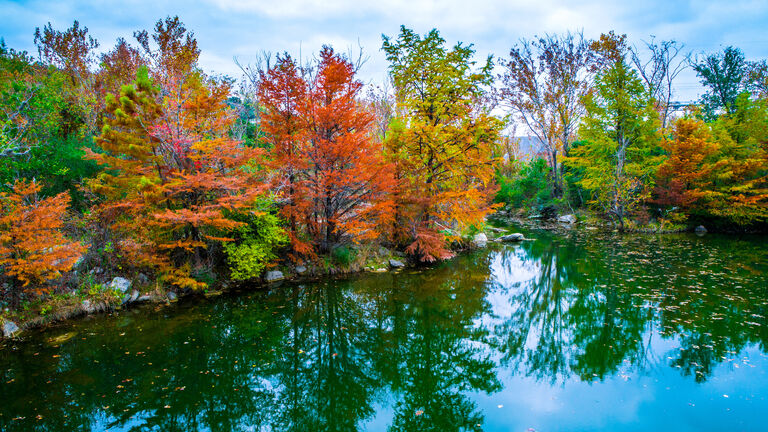 Tranquil Fall Leaves along mirrored water reflection at Red Bud Isle