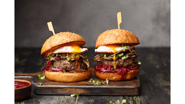 Junk food - homemade beef burgers on vintage wooden background