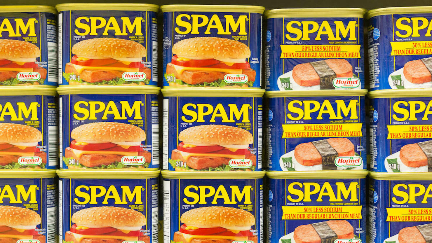 Spam canned meat stacked vertically in store shelf. Spam is