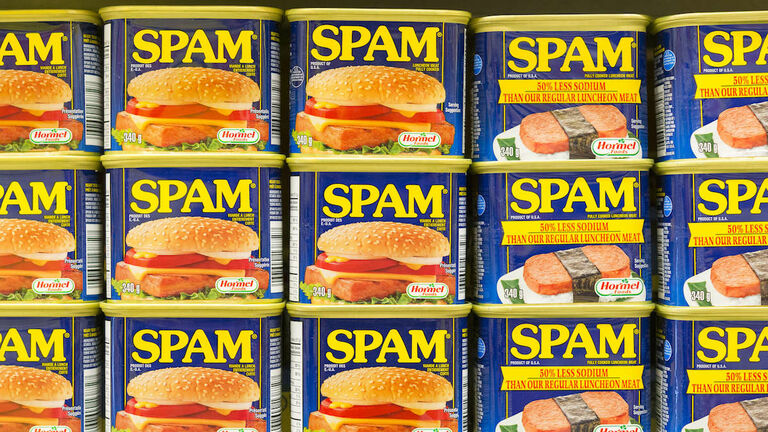 Spam canned meat stacked vertically in store shelf. Spam is