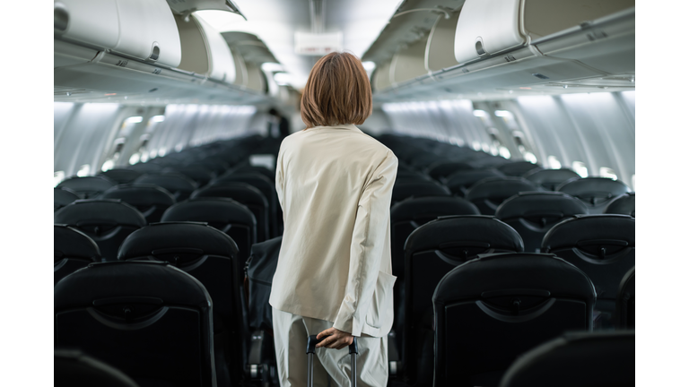 Businesswoman traveling on an airplane to a business destination