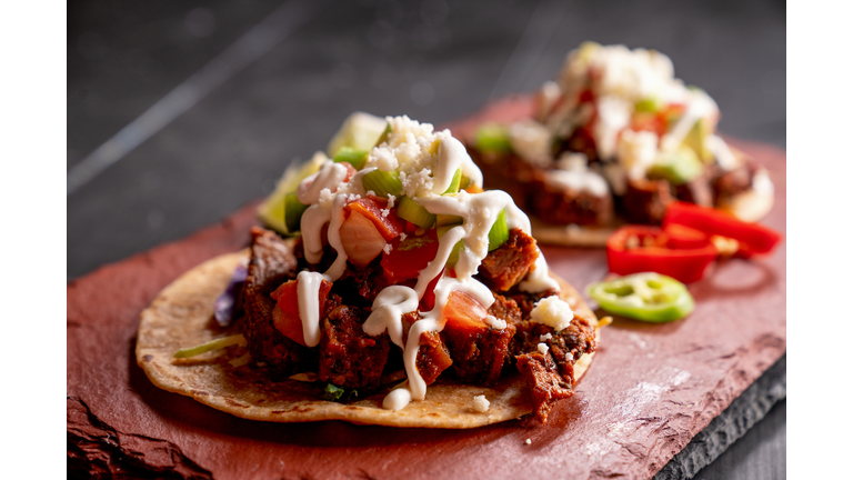 Beef Carne Asada Mexican Tijuana Style Street Food Tacos with Marinated Steak, Cilantro, Onion, Cotija Cheese and Sour Cream