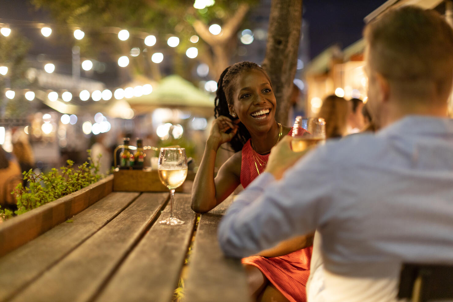 Couple drinking wine together outdoors at night