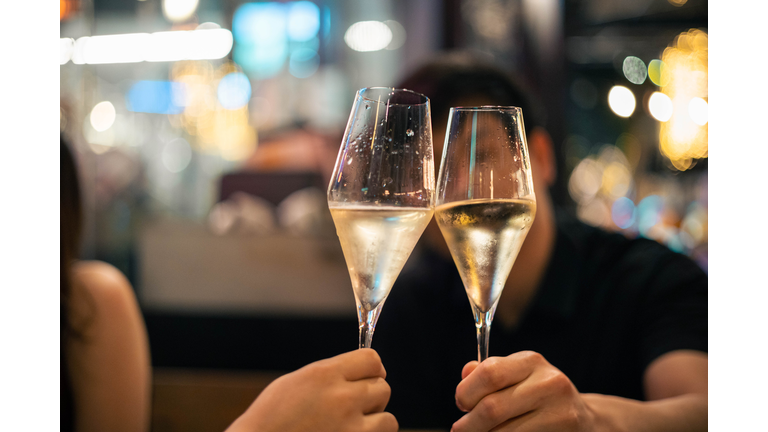Friends toasting/Cheering drinks and having fun during dinner party