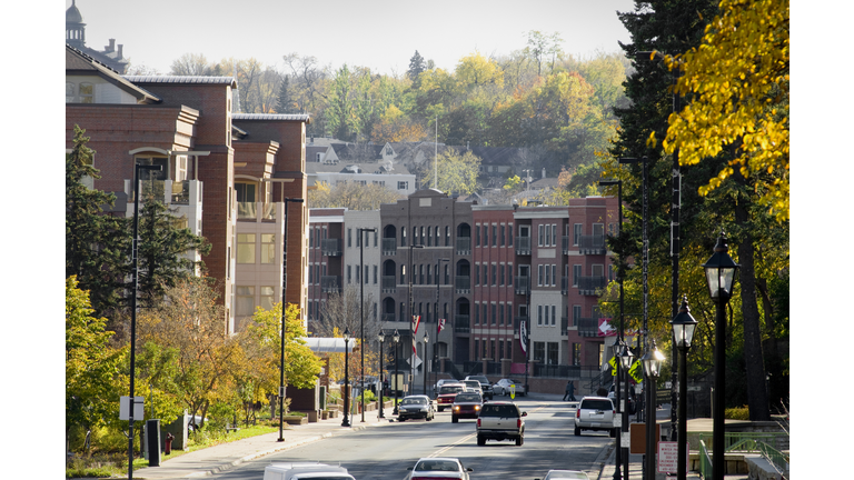 Street view of house building and green tress in Autumn