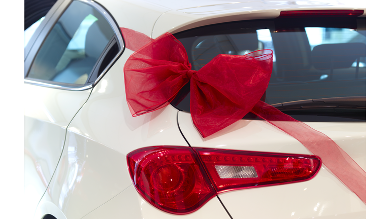 New car with red ribbon and red bow