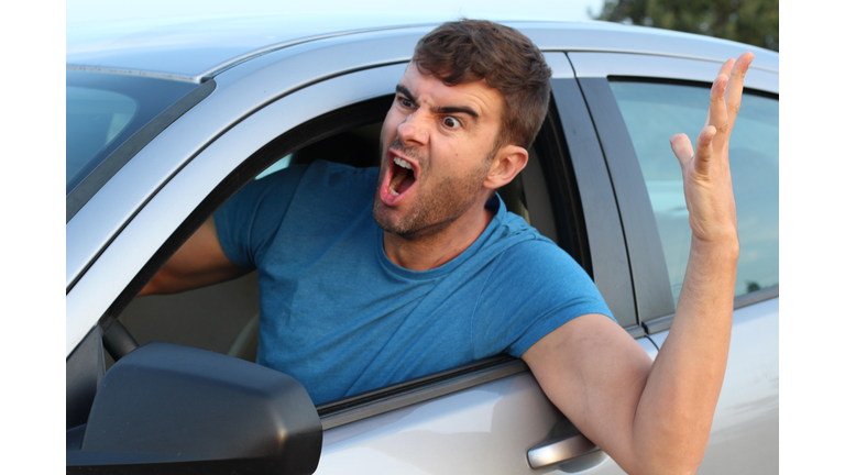 Angry man driving a car