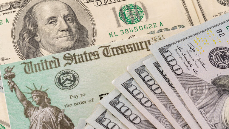 Illustration of the federal stimulus payment check with stack of cash surrounding payment