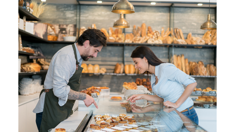 Woman buying cakes at a pastry shop