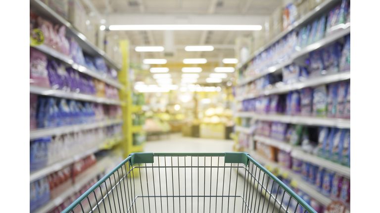 Supermarket store abstract blur background with shopping cart, Supermarket aisle with empty shopping cart