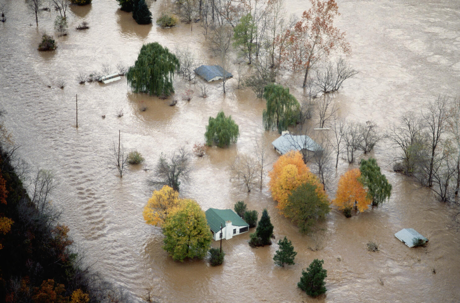 An Aerial View of Houses Surrounded by Flood Water