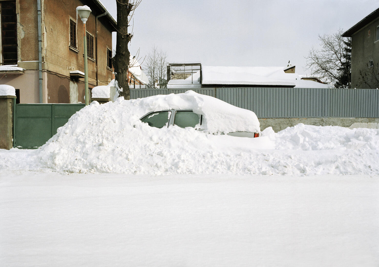 Car covered in snow drift