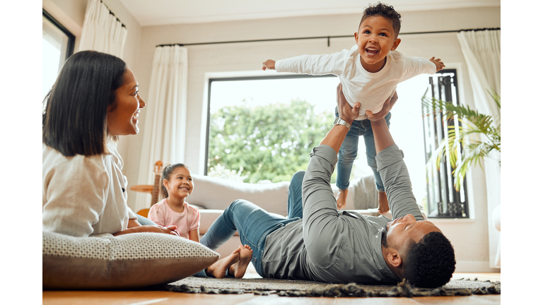 Shot of a young family playing together on the lounge floor at home