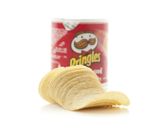 Pringles potato chips in front of can on white