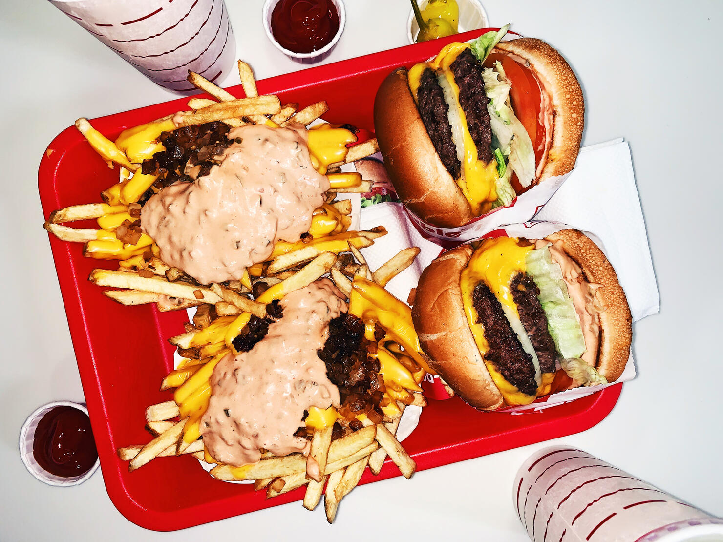 Two burgers with french fries and soda high angle view
