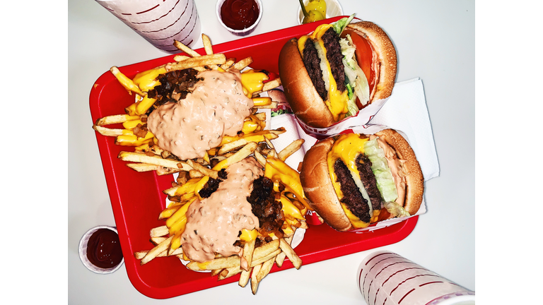 Two burgers with french fries and soda high angle view