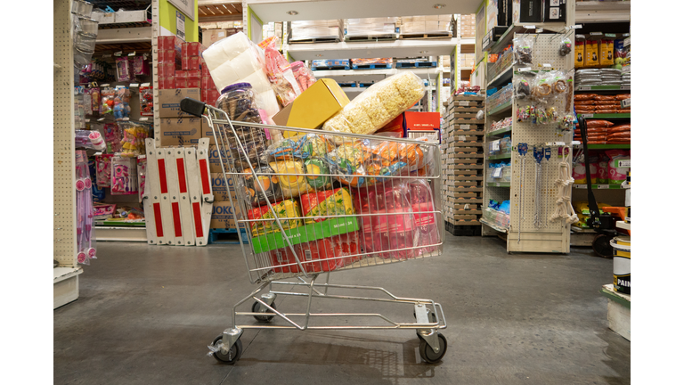 Trolley filled with groceries in wholesale store Landscape