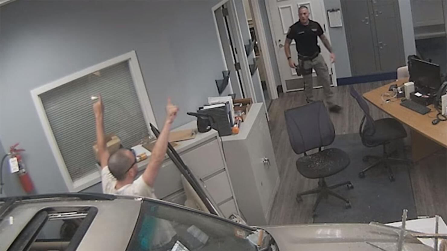 Driver crashes through police station