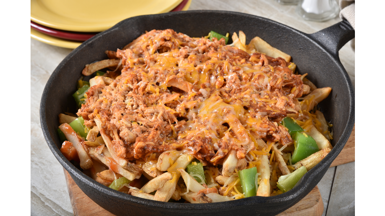 Loaded french fries in a cast iron skillet