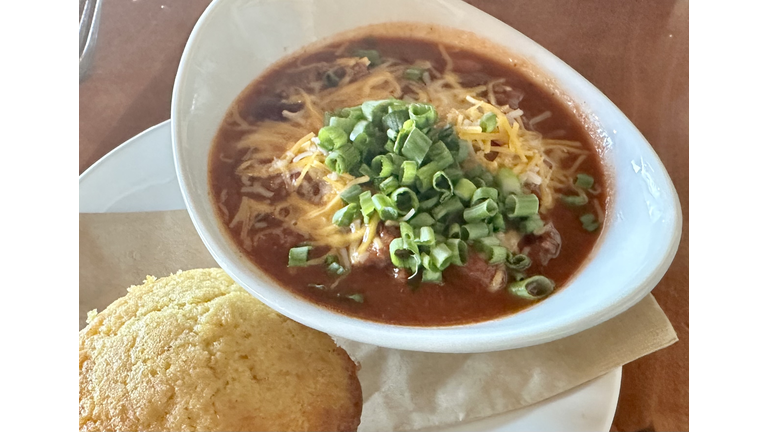 Fresh wild game chili and cornbread with onions and beans and cheese