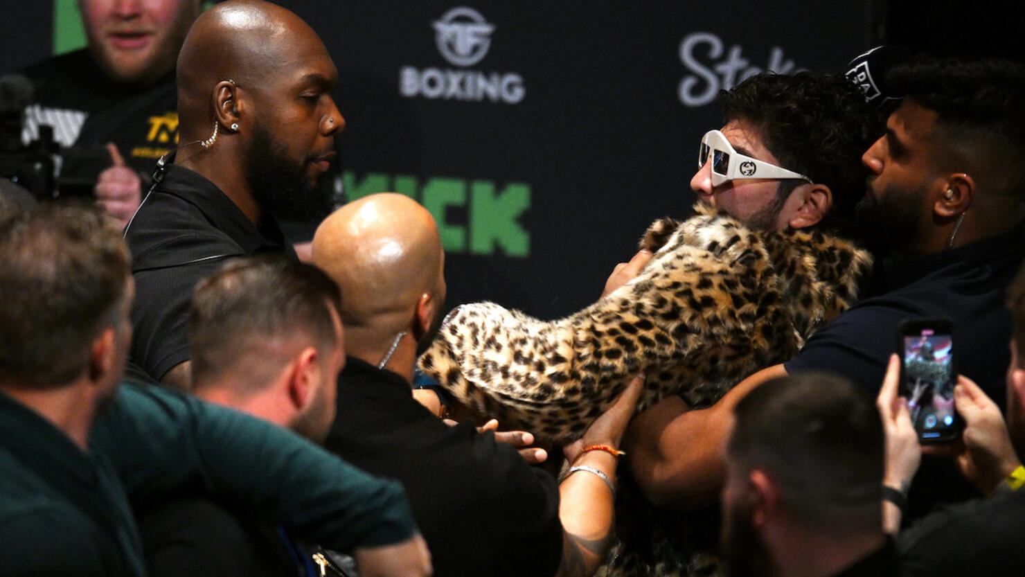 WATCH: Dillon Danis Hits Logan Paul With Mic, Brawl Ensues During Presser |  iHeart