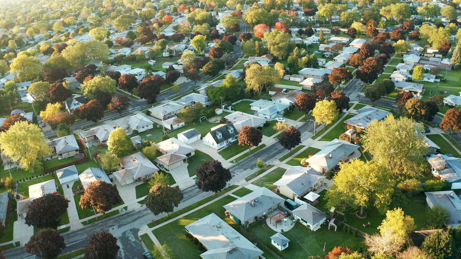 Aerial view of residential houses at autumn (october). American neighborhood, suburb. Real estate, drone shots, sunset, sunny morning,  sunlight, from above