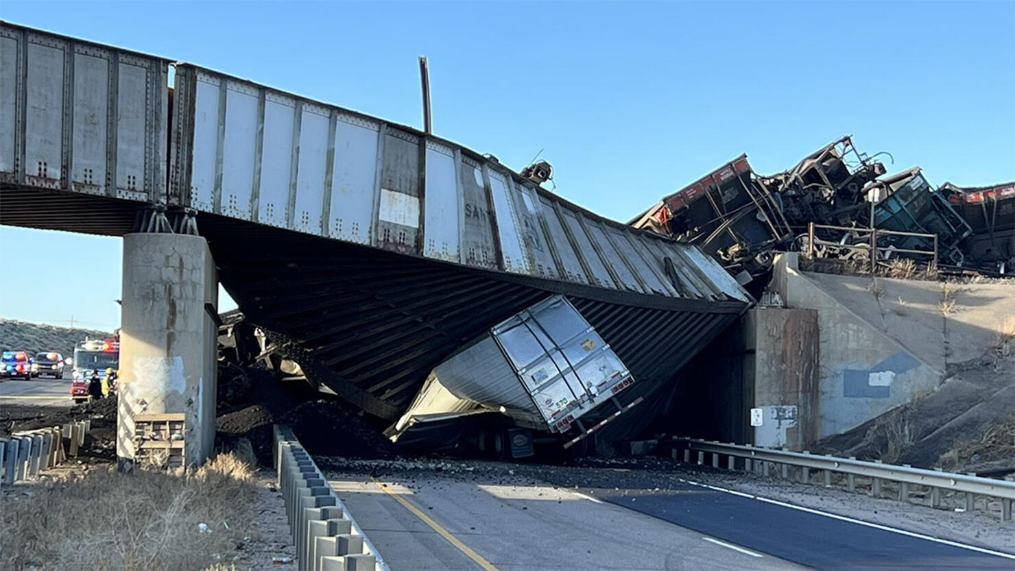 A railroad bridge collapse on top a tractor trailer