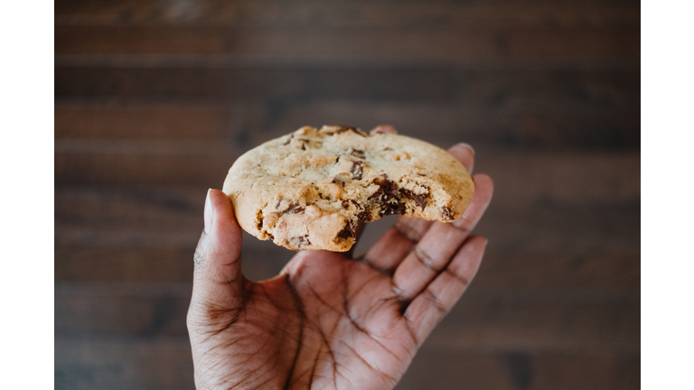 Woman Enjoys Giant Chocolate Chip Cookie