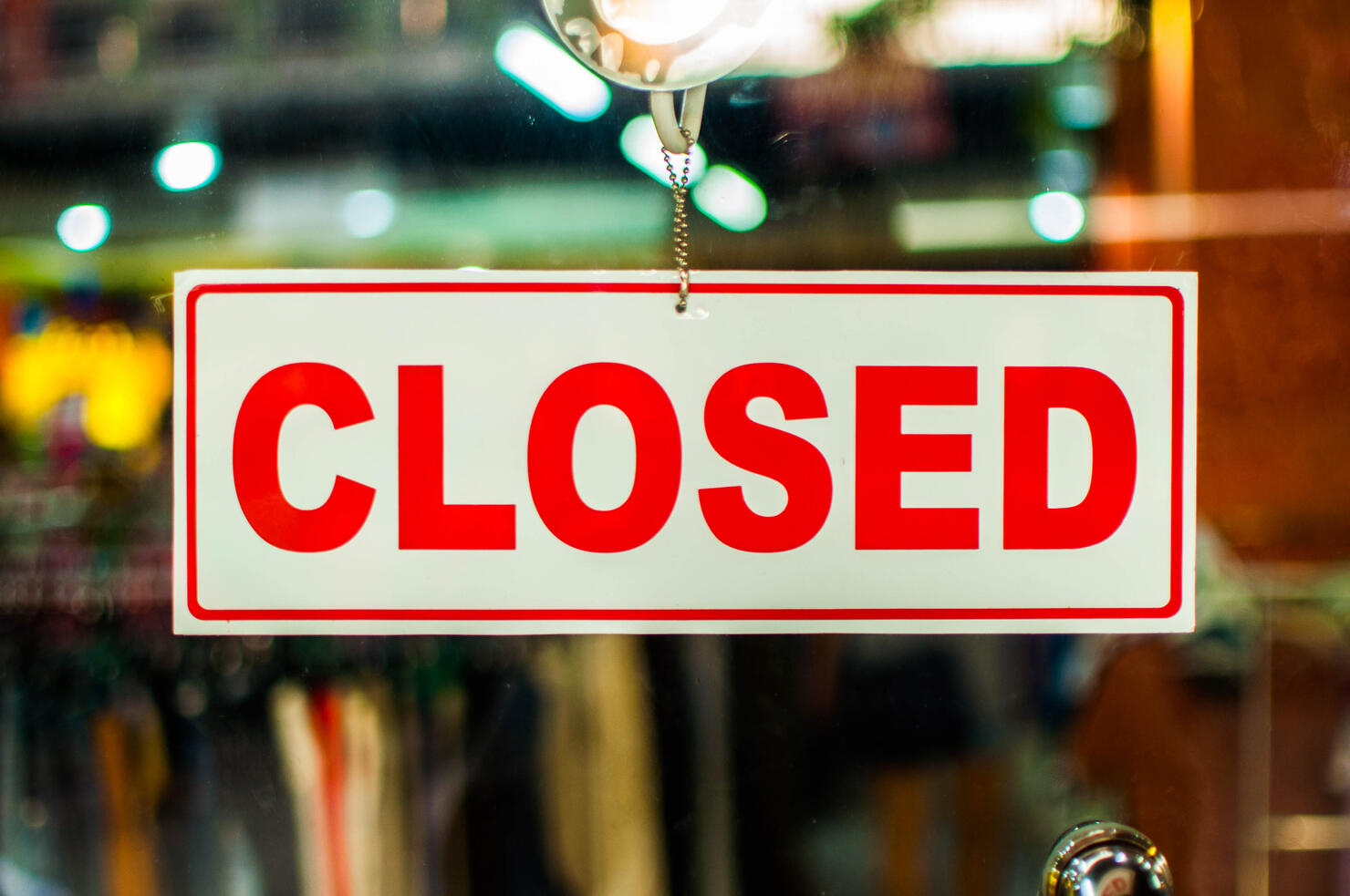 A glass door with "closed" store sign
