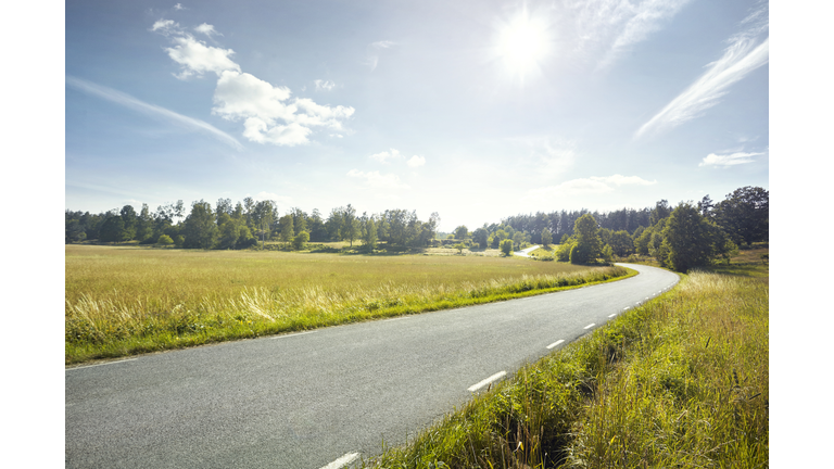 Empty road through fields