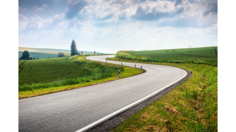 Curved S-shape road in Moravia fields