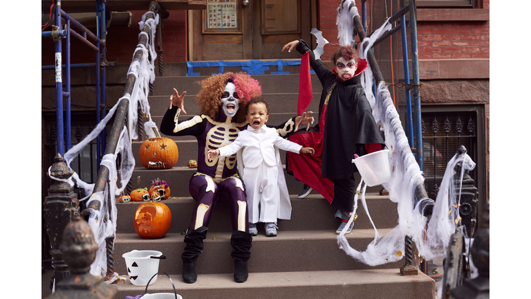 Mother and children wearing Halloween costumes