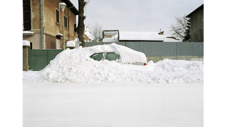 Car covered in snow drift