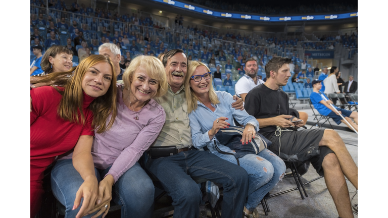 Smiling family sitting in stadium