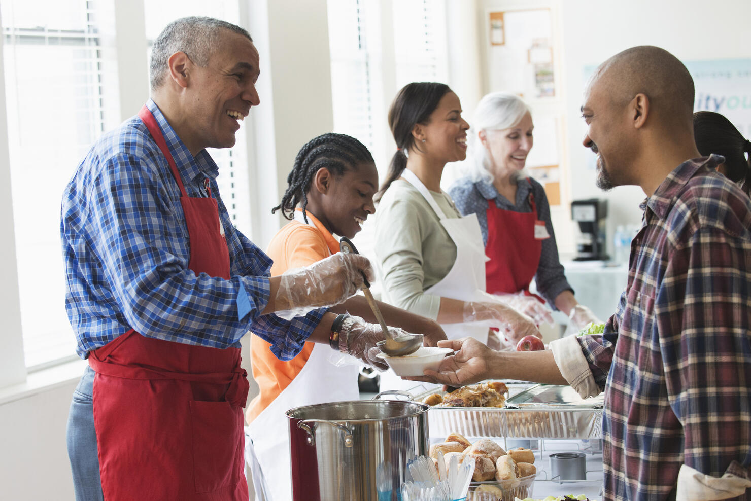 Volunteers serving food at community kitchen