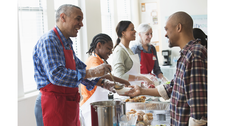 Volunteers serving food at community kitchen