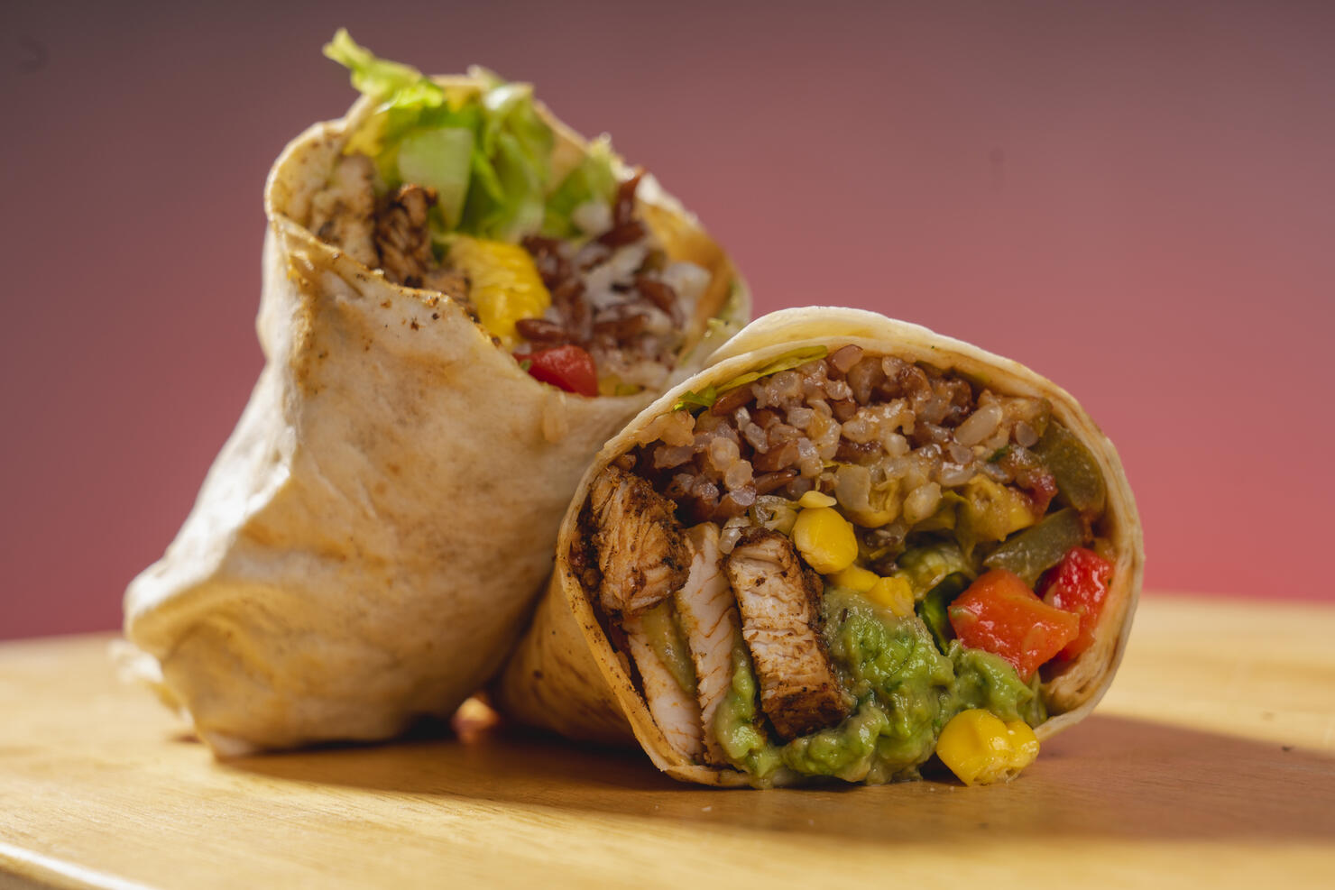 Barbecue chicken, corn and guacamole tortilla wraps on a wooden base. Vegetable burrito. Healthy food.
