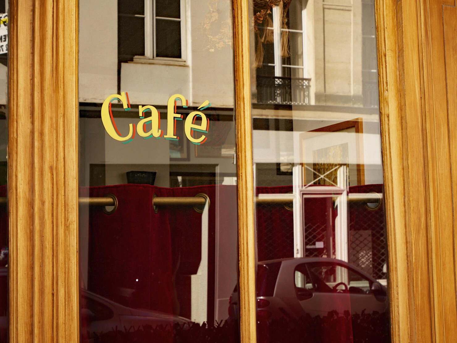 Close-up of the window of a retro-styled Parisian cafe