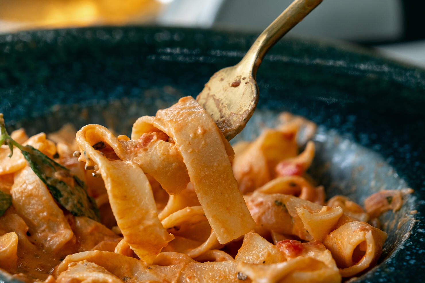 Vegetarian or vegan Italian pasta in tomato sauce. Cooking and serving vegan dishes at home, in a cafe or restaurant. Spaghetti with sliced vegetables, in a beautiful plate, on the dining table. Vegetable food. Sustainable development. Ethical consumption