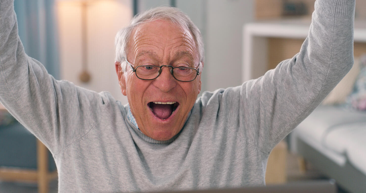 Senior, man or laptop excited in home online streaming, entertainment or sports team win. Male person, wow emoji or internet celebration announcement, competition supporter or happy cheers victory